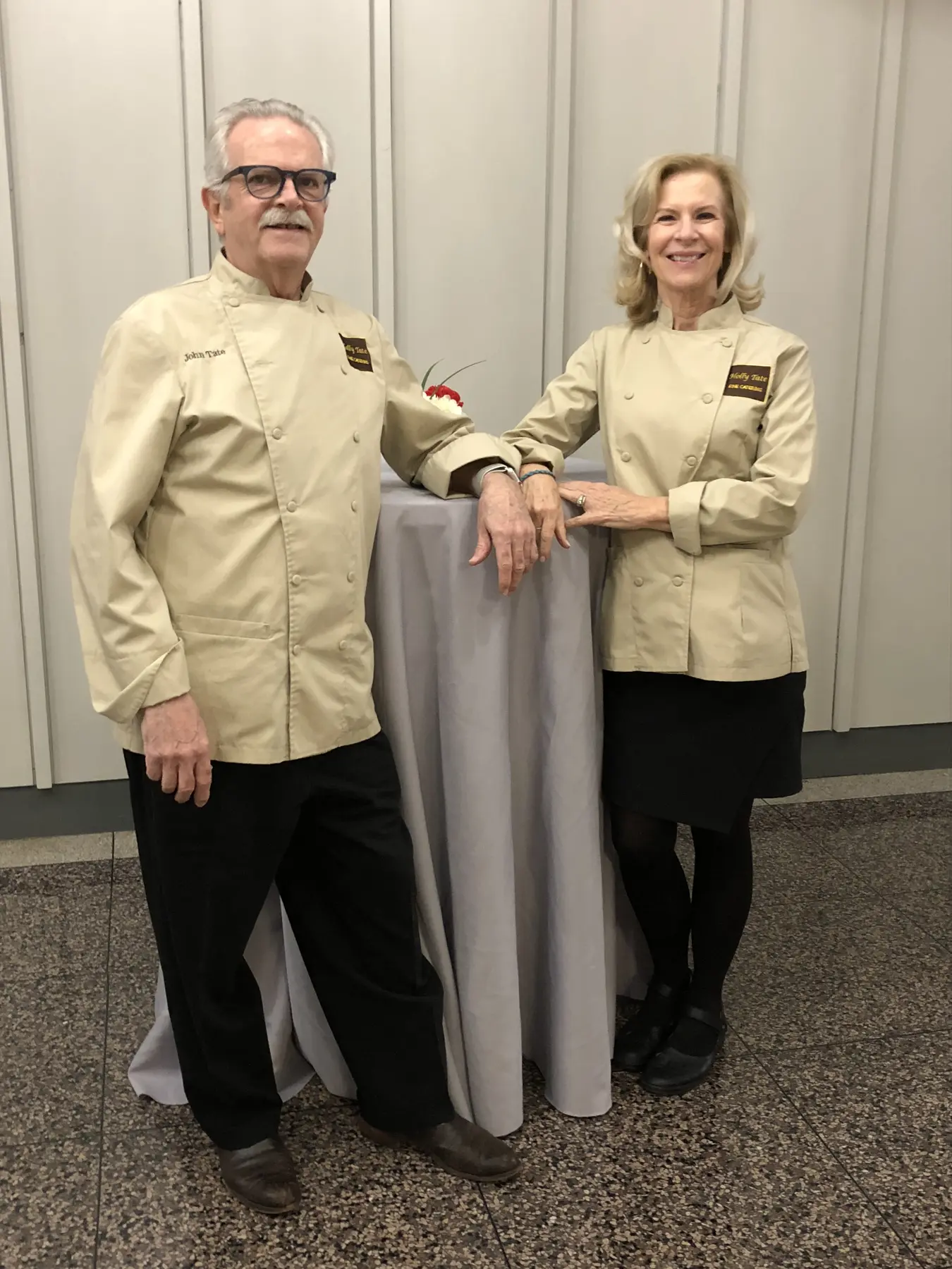 John and Holly Tate together in matching tan chef jackets.