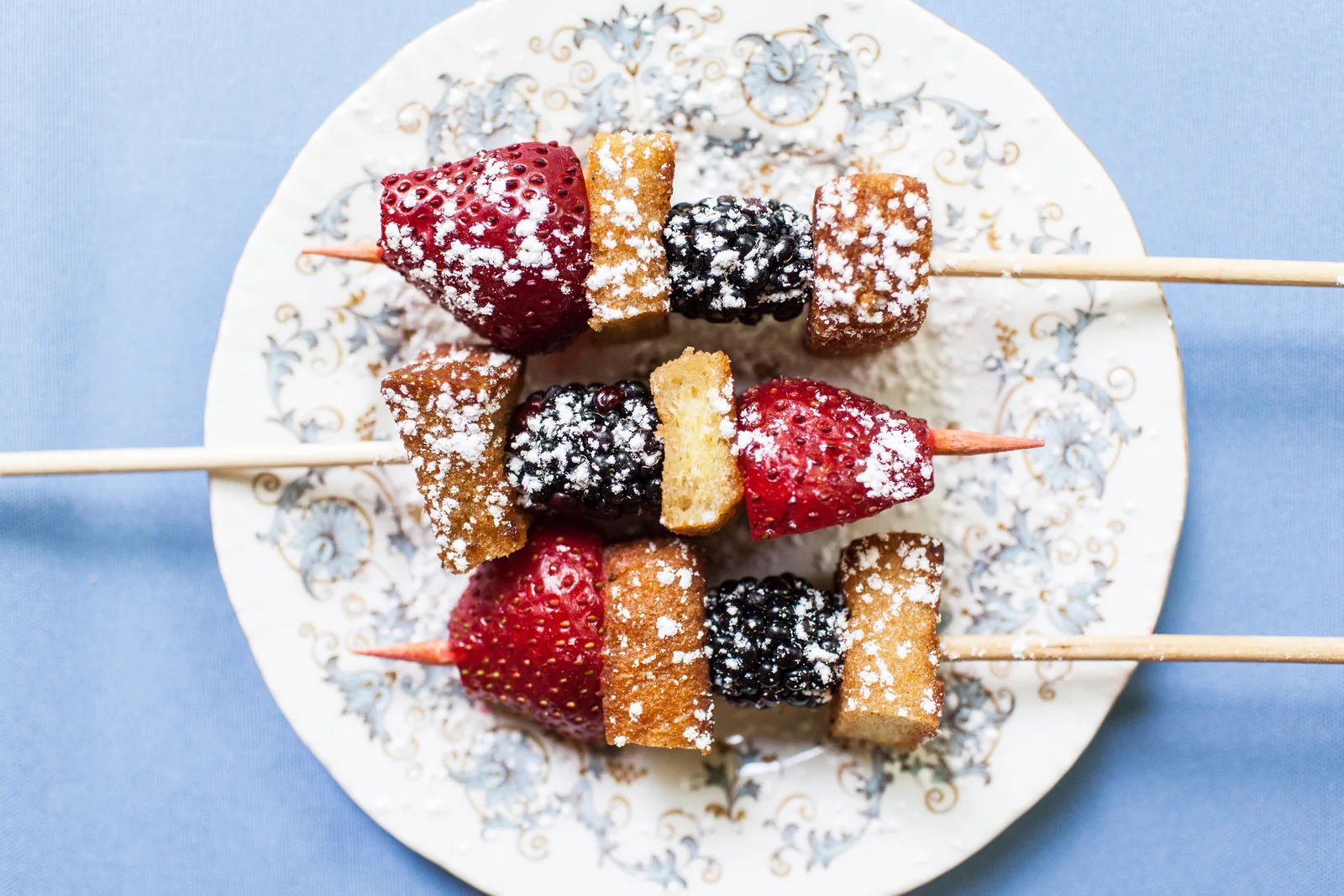 Skewers of fresh berries and pound cake dusted with powdered sugar